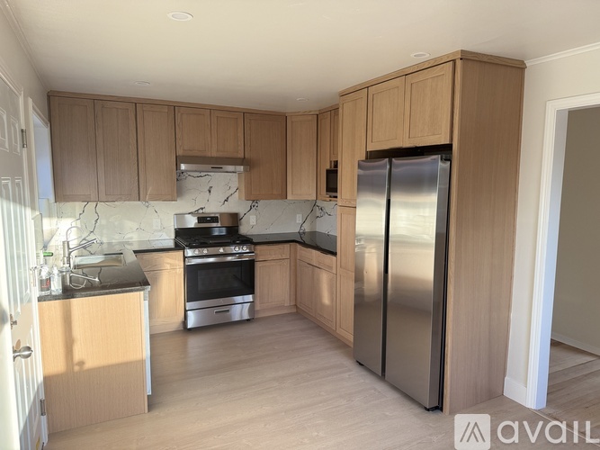 A kitchen with wooden cabinets and stainless steel appliances.