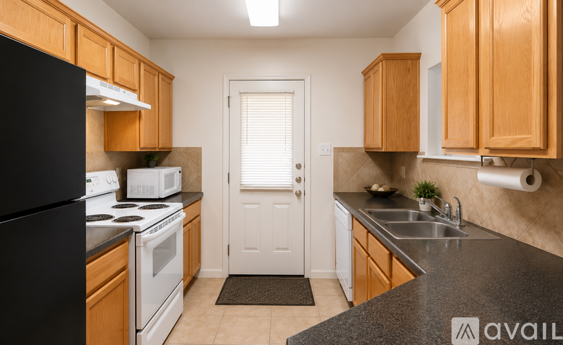 A kitchen with black appliances and wooden cabinets.
