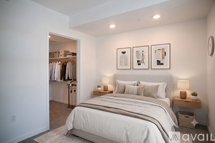 A bedroom with a large bed and a walk-in closet.