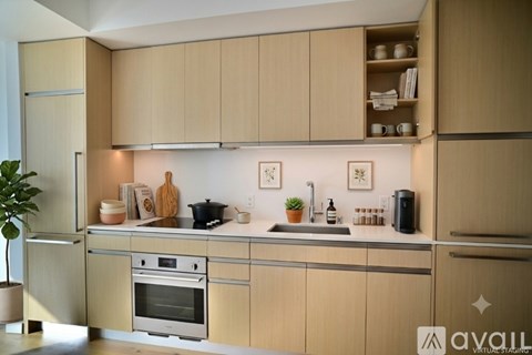 A kitchen with wooden cabinets and stainless steel appliances.