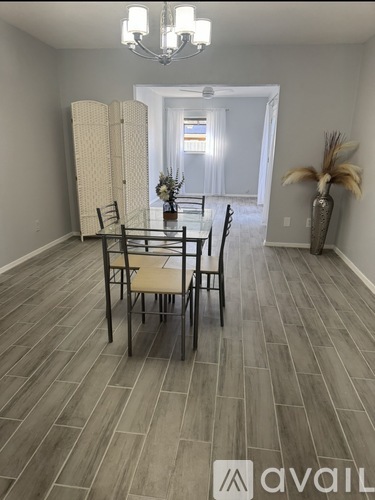 A dining room with a table set for four.