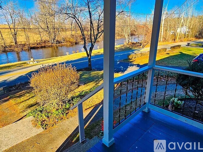 A balcony overlooks a river and a residential area.