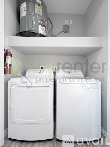 A white toilet and a white washing machine in a small room.