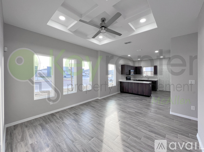 A spacious living room with a ceiling fan and a television.