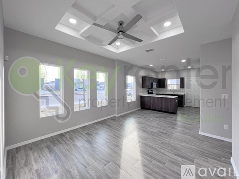 A spacious living room with a ceiling fan and a television.