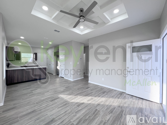 A spacious room with a ceiling fan and lighting fixtures.