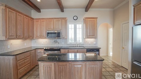 A kitchen with wooden cabinets and a black countertop.
