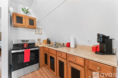 A kitchen with wooden cabinets and a black stove top oven.