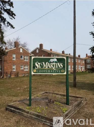 A sign for St. Martins Cooperative is displayed in a garden bed.