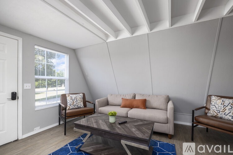 A living room with a couch, chair, and coffee table.