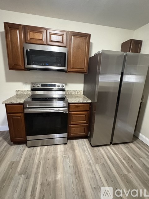 A kitchen with a stainless steel refrigerator and oven.
