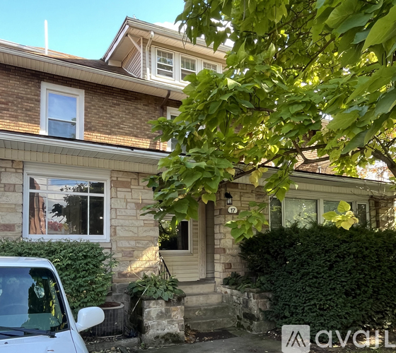 A house with a car parked in front.