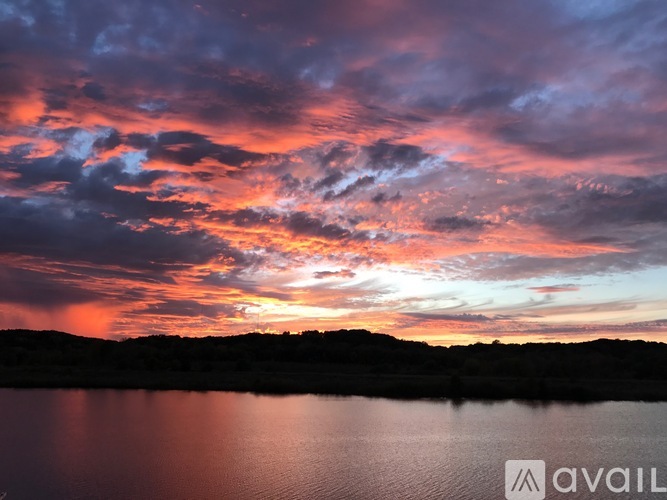 A beautiful sunset over a calm body of water.