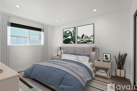 A bedroom with a large bed and a plant on the side table.