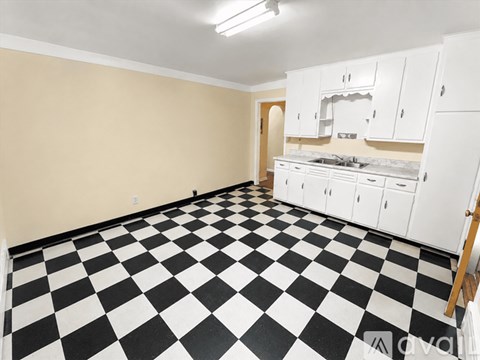 A kitchen with black and white checkered floor.