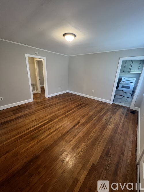 A room with wooden flooring and a white ceiling.