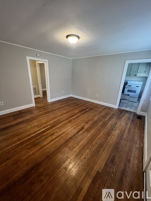 A room with wooden flooring and a white ceiling.