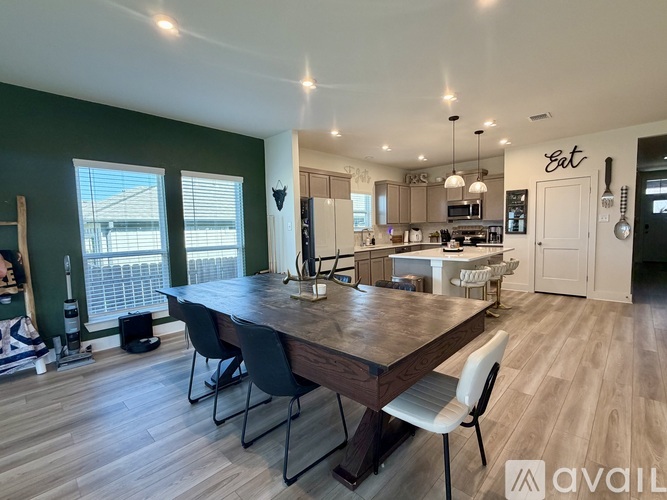 A dining area with a wooden table and chairs.