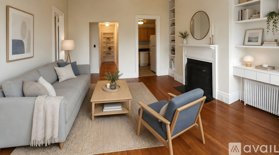 A living room with a grey couch, a wooden coffee table, and a fireplace.
