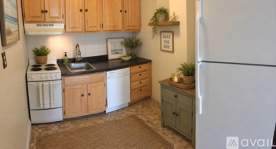 A kitchen with wooden cabinets and a white refrigerator.