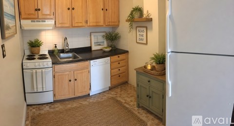 A kitchen with wooden cabinets and a white refrigerator.