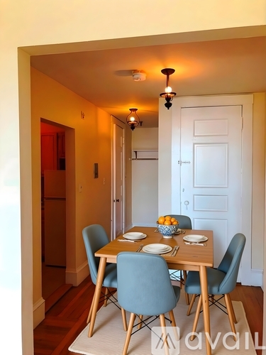 A dining room with a table set for four.