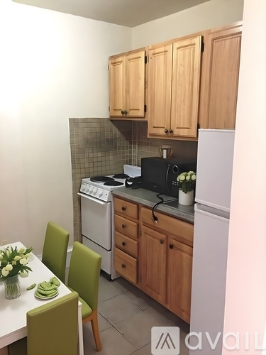 A kitchen with wooden cabinets and a white refrigerator.