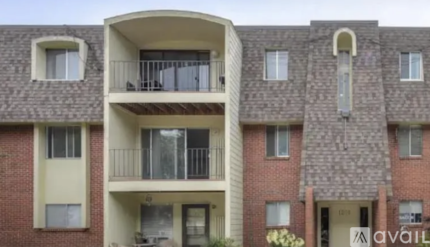 Apartment building with balconies and doors numbered 101 to 105.