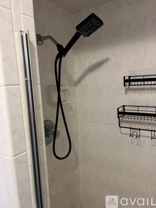 A shower head with a hose attached to it.
