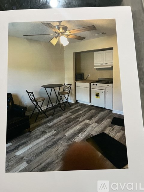 A kitchen with a table and chairs.