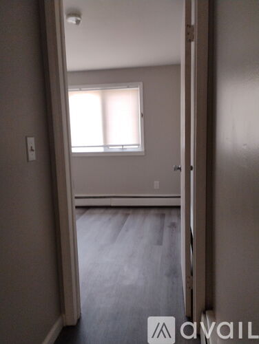 A room with a window and a door.