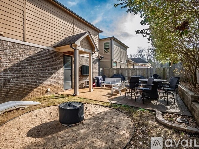 A backyard with a patio and a trash bag.