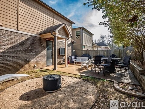 A backyard with a patio and a trash bag.