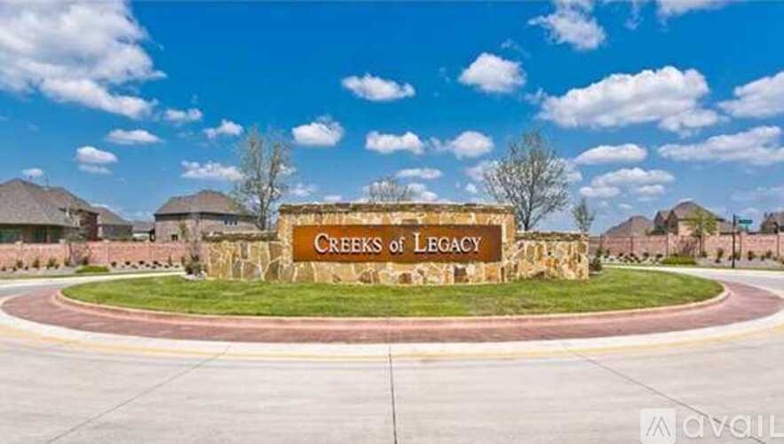A sign that says Creeks of Legacy stands in front of a building.