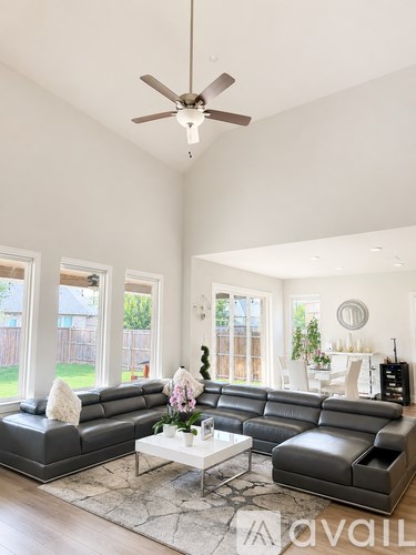 A living room with a large sectional sofa and a coffee table.