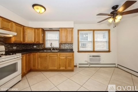 A kitchen with wooden cabinets and a white stove top oven.