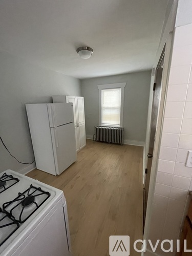 A kitchen with a stove top oven and a refrigerator.