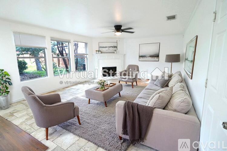 A living room with a couch, chair, and a rug.