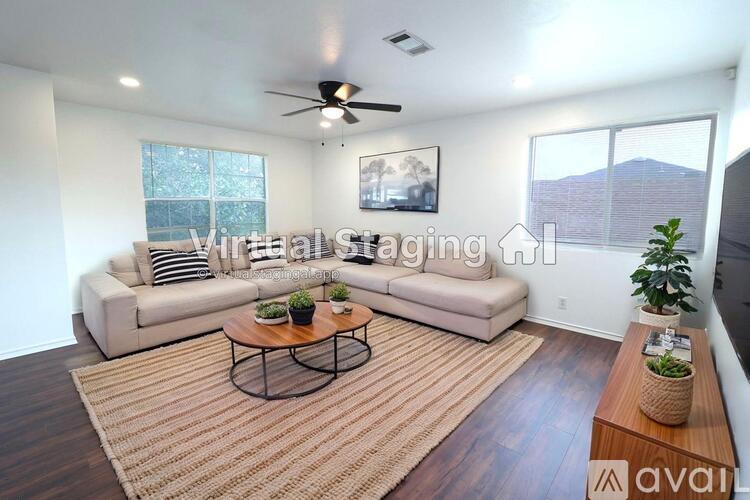 A living room with a couch, a coffee table, and a plant.