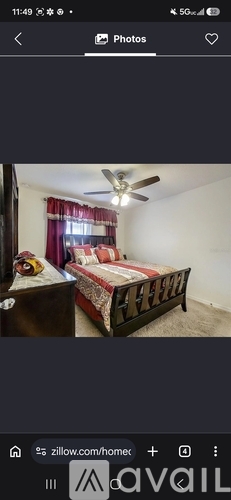 A bedroom with a bed and a ceiling fan.