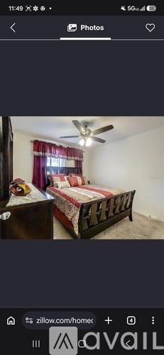 A bedroom with a bed and a ceiling fan.