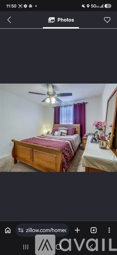 A bedroom with a bed, dresser, and ceiling fan.