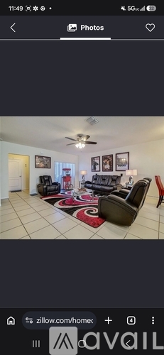 A living room with a couch, chair, and rug.