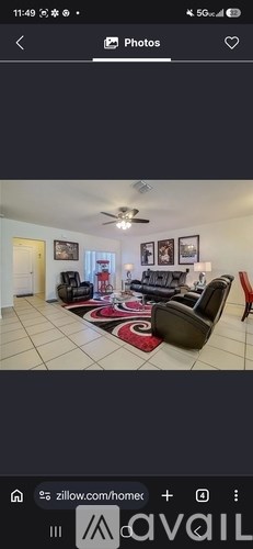 A living room with a couch, chair, and rug.