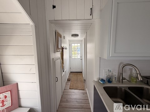 A kitchen with a sink and a window.