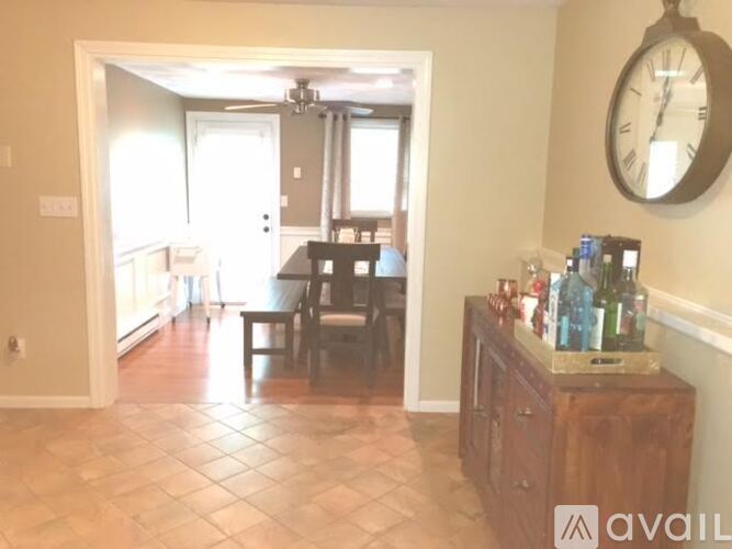 A living room with a dining table and chairs.