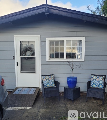 A small house with a white door and a wreath on it.