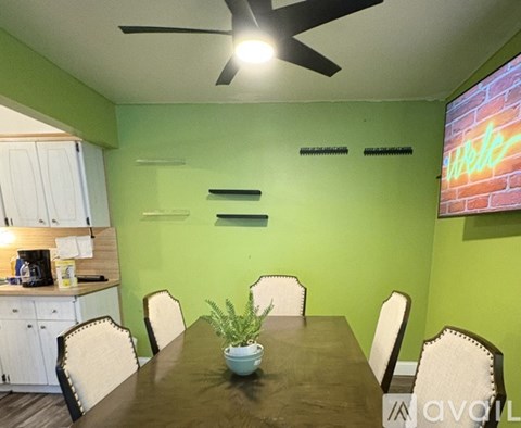 A dining room with a table set for four.