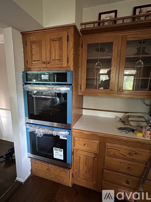 A kitchen with wooden cabinets and a blue oven.