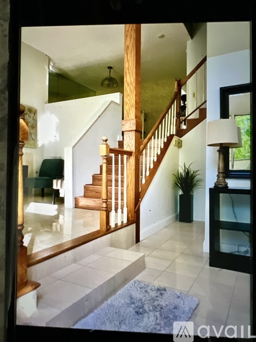A wooden staircase with a white landing.